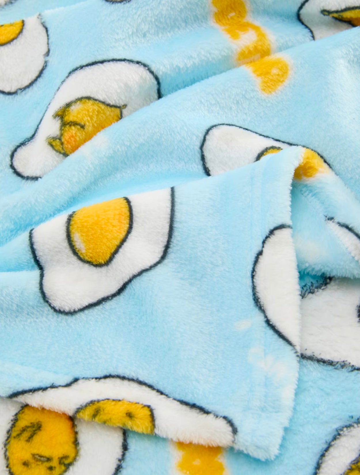 Close-up of Gudetama design on blue blanket