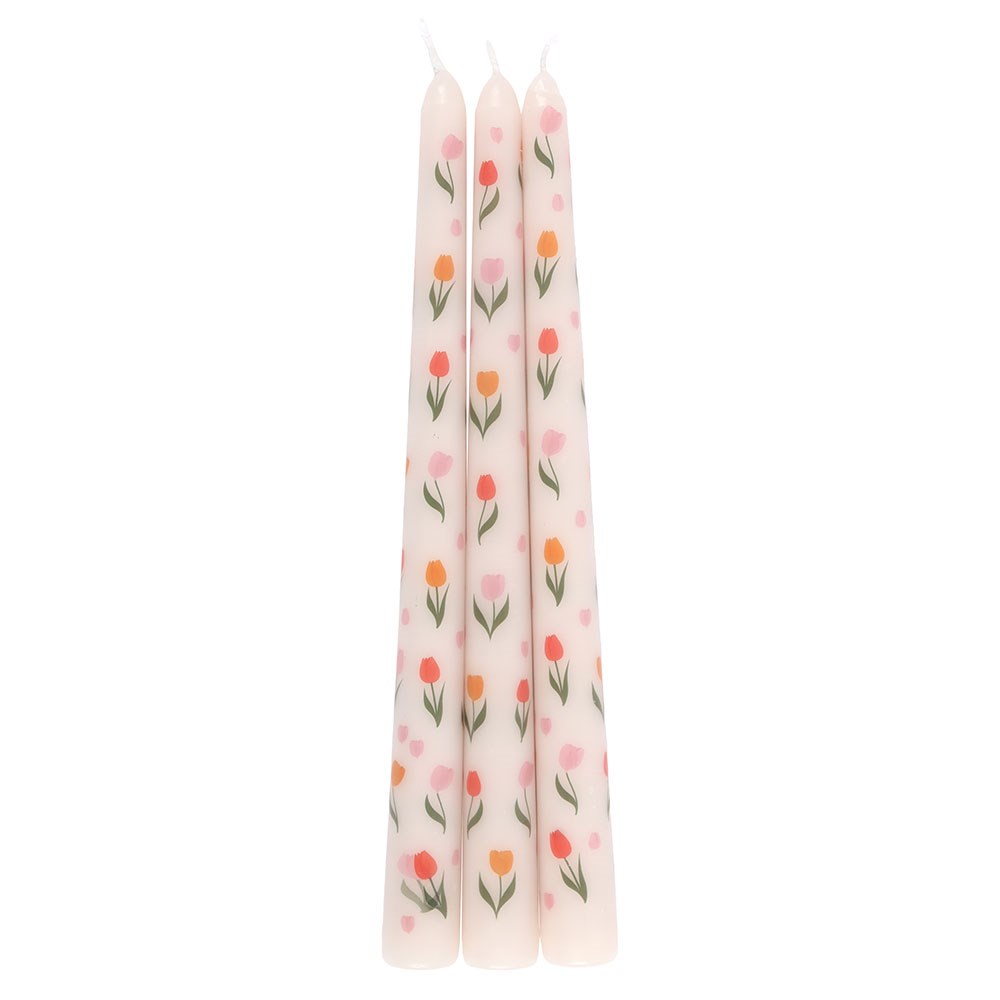 Three pastel tulip design taper candles on white background